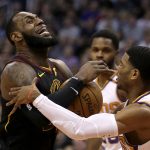 Cleveland Cavaliers forward LeBron James (23) gets fouled by Phoenix Suns guard Shaquille Harrison in the first half during an NBA basketball game, Tuesday, March 13, 2018, in Phoenix. (AP Photo/Rick Scuteri)