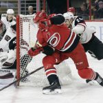 Arizona Coyotes goalie Darcy Kuemper (35) and teammate Oliver Ekman-Larsson, right, of Sweden, defend against Carolina Hurricanes' Jeff Skinner during the second period of an NHL hockey game in Raleigh, N.C., Thursday, March 22, 2018. (AP Photo/Gerry Broome)