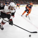 Arizona Coyotes' Brendan Perlini (11) is chased by Edmonton Oilers' Connor McDavid (97) during the third period of an NHL hockey game, Monday, March 5, 2018, in Edmonton, Alberta. Edmonton won 4-3 in overtime. (Jason Franson/The Canadian Press via AP)