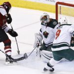 Arizona Coyotes center Christian Dvorak (18) scores a goal against Minnesota Wild goaltender Alex Stalock, second from right, as center Mikko Koivu (9) watches during the third period of an NHL hockey game Thursday, March 1, 2018, in Glendale, Ariz. The Coyotes defeated the Wild 5-3. (AP Photo/Ross D. Franklin)