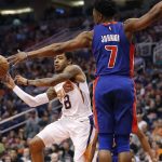 Phoenix Suns guard Tyler Ulis (8) passes the ball as Detroit Pistons forward Stanley Johnson (7) defends during the second half of an NBA basketball game Tuesday, March 20, 2018, in Phoenix. (AP Photo/Matt York)
