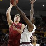 Stanford forward Reid Travis shoots over Arizona State forward Romello White, right, during the first half of an NCAA college basketball game Saturday, March 3, 2018, in Tempe, Ariz. (AP Photo/Matt York)