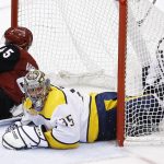 Nashville Predators goaltender Pekka Rinne (35) ends up in the dislodged net after getting hit by Arizona Coyotes right wing Josh Archibald (45) during the third period of an NHL hockey game Thursday, March 15, 2018, in Glendale, Ariz. The Predators defeated the Coyotes 3-2. (AP Photo/Ross D. Franklin)
