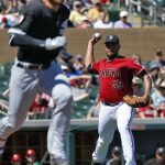 Arizona Diamondbacks pitcher Albert Suarez, right, throws out Chicago White Sox Yoan Moncada on a bunt-attempt during the first inning of a spring training baseball game Monday, March 19, 2018, in Scottsdale, Ariz. (AP Photo/Matt York)