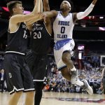 Rhode Island guard E.C. Matthews (0) shoots in front of Davidson forward Oskar Michelsen (15) and guard KiShawn Pritchett (20) during the first half of an NCAA college basketball championship game in the Atlantic 10 Conference tournament, Sunday, March 11, 2018, in Washington. (AP Photo/Alex Brandon)