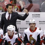 Ottawa Senators head coach Guy Boucher, top, gestures to his goalie to come off the ice as Boucher stands behind left wing Mike Hoffman, left, center Jean-Gabriel Pageau (44), center Jim O'Brien (40) and left wing Max McCormick, right, during the third period of an NHL hockey game against the Arizona Coyotes, Saturday, March 3, 2018, in Glendale, Ariz. (AP Photo/Ross D. Franklin)