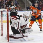 Arizona Coyotes goalie Darcy Kuemper (35) makes the save as Edmonton Oilers' Ryan Nugent-Hopkins (93) looks for the rebound during second-period NHL hockey game action in Edmonton, Alberta, Monday, March 5, 2018. (Jason Franson/The Canadian Press via AP)