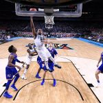 Villanova guard Phil Booth (5) drives to the basket in front of Kansas guard Devonte' Graham, left, during the first half in the semifinals of the Final Four NCAA college basketball tournament, Saturday, March 31, 2018, in San Antonio. (AP Photo/Chris Steppig, NCAA Photos Pool)