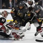 Arizona Coyotes goaltender Antti Raanta blocks a shot by Vegas Golden Knights right wing Ryan Reaves (75) and center Oscar Lindberg (24) during the second period of an NHL hockey game, Wednesday, March 28, 2018, in Las Vegas. (AP Photo/John Locher)