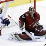Arizona Coyotes goaltender Antti Raanta (32) makes the save in front of St. Louis Blues defenseman Robert Bortuzzo in the third period during an NHL hockey game, Saturday, March 31, 2018, in Glendale, Ariz. (AP Photo/Rick Scuteri)