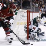 Arizona Coyotes left wing Jordan Martinook, left, tries to get off a shot against Minnesota Wild goaltender Devan Dubnyk (40) during the second period of an NHL hockey game Saturday, March 17, 2018, in Glendale, Ariz. The Wild won 3-1. (AP Photo/Ross D. Franklin)