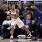 Phoenix Suns' Tyler Ulis, left, passes the ball around Orlando Magic's Shelvin Mack, right, during the first half of an NBA basketball game, Saturday, March 24, 2018, in Orlando, Fla. (AP Photo/John Raoux)