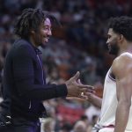 Former NBA basketball player Amar'e Stoudemire, left, greets Miami Heat's Justise Winslow (20) during the first half of an NBA basketball game between the Miami Heat and Phoenix Suns, Monday, March 5, 2018, in Miami. (AP Photo/Lynne Sladky)