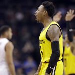 UMBC's Jourdan Grant (5) celebrates after a basket against Virginia during the second half of a first-round game in the NCAA men's college basketball tournament in Charlotte, N.C., Friday, March 16, 2018. (AP Photo/Gerry Broome)
