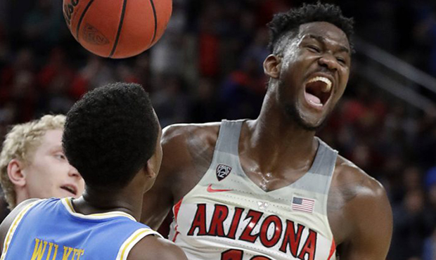 Arizona's Deandre Ayton (13) celebrates after scoring during overtime in the team's NCAA college ba...