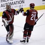 Arizona Coyotes goaltender Antti Raanta (32) celebrates with Dylan Strome (20) after shutting out the St. Louis Blues 5-0 during an NHL hockey game, Saturday, March 31, 2018, in Glendale, Ariz. (AP Photo/Rick Scuteri)