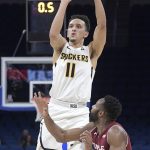 Wichita State guard Landry Shamet (11) goes up for a shot in front of Temple guard Josh Brown (1) during the first half of an NCAA college basketball game in the quarterfinals of the American Athletic Conference tournament, Friday, March 9, 2018, in Orlando, Fla. (AP Photo/Phelan M. Ebenhack)