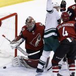 Minnesota Wild center Mikko Koivu, middle, celebrates his goal against Arizona Coyotes goaltender Antti Raanta, left, as Coyotes defenseman Niklas Hjalmarsson (4) watches during the third period of an NHL hockey game Thursday, March 1, 2018, in Glendale, Ariz. The Coyotes defeated the Wild 5-3. (AP Photo/Ross D. Franklin)