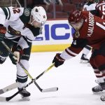 Minnesota Wild center Eric Staal (12) and Arizona Coyotes defenseman Niklas Hjalmarsson (4) battle for the puck during the first period of an NHL hockey game Thursday, March 1, 2018, in Glendale, Ariz. (AP Photo/Ross D. Franklin)