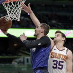 Orlando Magic's Mario Hezonja, left, makes a basket as he gets past Phoenix Suns' Dragan Bender (35) during the first half of an NBA basketball game, Saturday, March 24, 2018, in Orlando, Fla. (AP Photo/John Raoux)