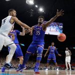 Villanova's Phil Booth (5) passes the ball around Kansas's Udoka Azubuike (35) during the first half in the semifinals of the Final Four NCAA college basketball tournament, Saturday, March 31, 2018, in San Antonio. (AP Photo/Eric Gay)