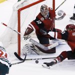 Arizona Coyotes goaltender Antti Raanta (32) gets some help from defenseman Alex Goligoski (33) on a shot from Minnesota Wild defenseman Matt Dumba (24) during the third period of an NHL hockey game Thursday, March 1, 2018, in Glendale, Ariz. The Coyotes defeated the Wild 5-3. (AP Photo/Ross D. Franklin)