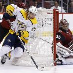 Nashville Predators left wing Kevin Fiala (22) tries to shoot against Arizona Coyotes goaltender Darcy Kuemper (35) during the first period of an NHL hockey game Thursday, March 15, 2018, in Glendale, Ariz. (AP Photo/Ross D. Franklin)