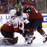 Arizona Coyotes defenseman Kevin Connauton (44) sends Ottawa Senators right wing Mark Stone (61) to the ice as they collide with Coyotes goaltender Antti Raanta, left, during the first period of an NHL hockey game Saturday, March 3, 2018, in Glendale, Ariz. (AP Photo/Ross D. Franklin)