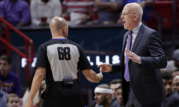 Phoenix Suns head coach Jay Triano, right, talks with referee Jacyn Goble (68) during the first hal...