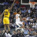 Virginia's Nigel Johnson (23) drives past UMBC's Arkel Lamar (33) during the first half of a first-round game in the NCAA men's college basketball tournament in Charlotte, N.C., Friday, March 16, 2018. (AP Photo/Bob Leverone)