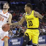 UMBC's Jairus Lyles (10) knocks the ball from Virginia's Ty Jerome (11) during the first half of a first-round game in the NCAA men's college basketball tournament in Charlotte, N.C., Friday, March 16, 2018. (AP Photo/Gerry Broome)