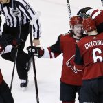 Arizona Coyotes defenseman Kevin Connauton, right, obscured, celebrates his goal against the Minnesota Wild with center Christian Dvorak (18), left wing Max Domi and defenseman Jakob Chychrun (6) during the third period of an NHL hockey game Thursday, March 1, 2018, in Glendale, Ariz. The Coyotes defeated the Wild 5-3. (AP Photo/Ross D. Franklin)