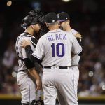 Colorado Rockies manager Bud Black (10) visits the mound to talk to catcher Chris Iannetta and relief pitcher Scott Oberg during the sixth inning of a baseball game against the Arizona Diamondbacks on Thursday, March 29, 2018, in Phoenix. (AP Photo/Matt York)