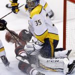 Arizona Coyotes right wing Josh Archibald, left, slides into Nashville Predators goaltender Pekka Rinne (35) during the third period of an NHL hockey game Thursday, March 15, 2018, in Glendale, Ariz. The Predators defeated the Coyotes 3-2. (AP Photo/Ross D. Franklin)
