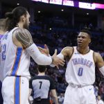 Oklahoma City Thunder guard Russell Westbrook (0) celebrates with teammate Steven Adams, next to Phoenix Suns center Alex Len, left, during the first half of an NBA basketball game in Oklahoma City, Thursday, March 8, 2018. (AP Photo/Sue Ogrocki)