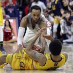 Arizona guard Parker Jackson-Cartwright, top, vies for a loose ball with California guard Don Coleman during the second half of an NCAA college basketball game, Saturday, March 3, 2018, in Tucson, Ariz. Arizona defeated California 66-54. (AP Photo/Rick Scuteri)