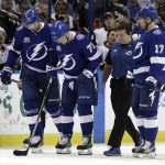 Tampa Bay Lightning left wing Adam Erne (73) is helped off the ice by Braydon Coburn (55), Alex Killorn (17) and trainer Tom Mulligan after getting hurt during the first period of an NHL hockey game against the Arizona Coyotes, Monday, March 26, 2018, in Tampa, Fla. (AP Photo/Chris O'Meara)