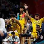 Michigan players on the bench watch during the second half in the semifinals of the Final Four NCAA college basketball tournament against Loyola-Chicago, Saturday, March 31, 2018, in San Antonio. (AP Photo/Charlie Neibergall)