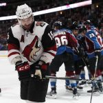 Arizona Coyotes center Brad Richardson, front, reacts as members of the Colorado Avalanche celebrate after a goal by Tyson Jost in the third period of an NHL hockey game Saturday, March 10, 2018, in Denver. The Avalanche won 5-2. (AP Photo/David Zalubowski)