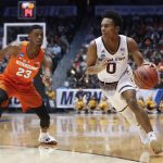 Arizona State's Tra Holder (0) drives past Syracuse's Frank Howard (23) during the first half of a First Four game of the NCAA men's college basketball tournament Wednesday, March 14, 2018, in Dayton, Ohio. (AP Photo/John Minchillo)
