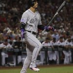 Colorado Rockies' Carlos Gonzalez flips his bat after striking out against the Arizona Diamondbacks during the first inning of a baseball game Thursday, March 29, 2018, in Phoenix. (AP Photo/Matt York)