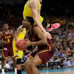 Michigan's Duncan Robinson fouls as Loyola-Chicago's Aundre Jackson tries to shoot during the second half in the semifinals of the Final Four NCAA college basketball tournament, Saturday, March 31, 2018, in San Antonio. (AP Photo/Eric Gay)