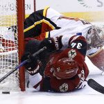 Arizona Coyotes center Zac Rinaldo (34) tries to get control of the puck after colliding with Calgary Flames goaltender Mike Smith during the second period of an NHL hockey game, Monday, March 19, 2018, in Glendale, Ariz. (AP Photo/Ross D. Franklin)