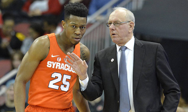 Syracuse head coach Jim Boeheim, right, talks with guard Tyus Battle (25) during the first half of ...