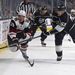 Arizona Coyotes center Nick Cousins (25) and Los Angeles Kings defenseman Kevin Gravel (53) compete for the puck during the first period of an NHL hockey game in Los Angeles on Thursday, March 29, 2018. (AP Photo/Reed Saxon)