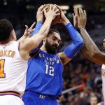 Oklahoma City Thunder center Steven Adams (12) gets tangled up with Phoenix Suns guard Devin Booker (1) and Phoenix Suns forward Marquese Chriss during the first half of an NBA basketball game Friday, March 2, 2018, in Phoenix. (AP Photo/Matt York)