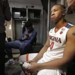 Virginia's Devon Hall (0) takes questions from the media in the locker room after losing to UMBC in a first-round game in the NCAA men's college basketball tournament in Charlotte, N.C., Friday, March 16, 2018. (AP Photo/Bob Leverone)