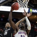 Colorado's Dominique Collier, left, covers a shot from Arizona's Deandre Ayton during the first half of an NCAA college basketball game in the quarterfinals of the Pac-12 men's tournament Thursday, March 8, 2018, in Las Vegas. (AP Photo/Isaac Brekken)