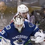 Arizona Coyotes right wing Josh Archibald (45) tries to squeeze behind Vancouver Canucks goaltender Jacob Markstrom during the third period of an NHL hockey game Wednesday, March 7, 2018, in Vancouver, British Columbia. (Jonathan Hayward/The Canadian Press via AP)