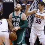Boston Celtics center Aron Baynes (46) gets stripped of the ball by Phoenix Suns forward Alan Williams (15) as Suns forward Dragan Bender (35) looks on during the second half of an NBA basketball game, Monday, March 26, 2018, in Phoenix. The Celtics defeated the Suns 102-94. (AP Photo/Ross D. Franklin)
